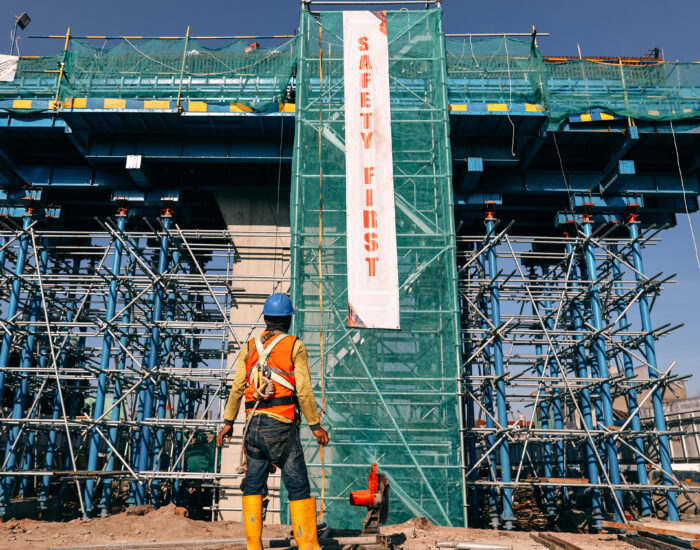 worker-at-construction-site-with-safety-first-bann-2021-09-04-09-41-39-utc